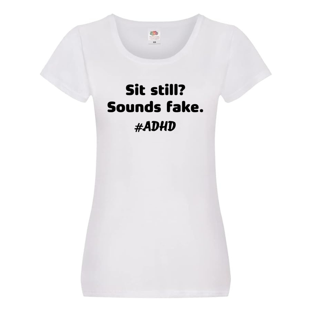 "SIT STILL? SOUNDS FAKE. #ADHD" TEE — (LADIES' FIT)